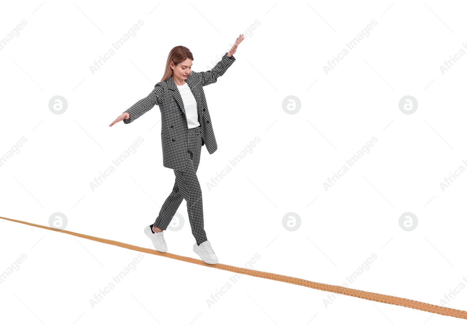 Image of Businesswoman walking rope against white background. Risk or balance concept