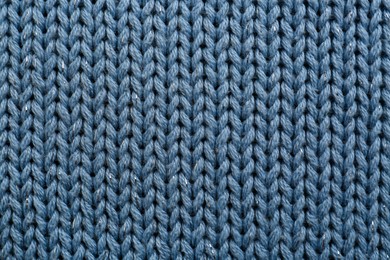 Photo of Beautiful pale blue knitted fabric as background, top view