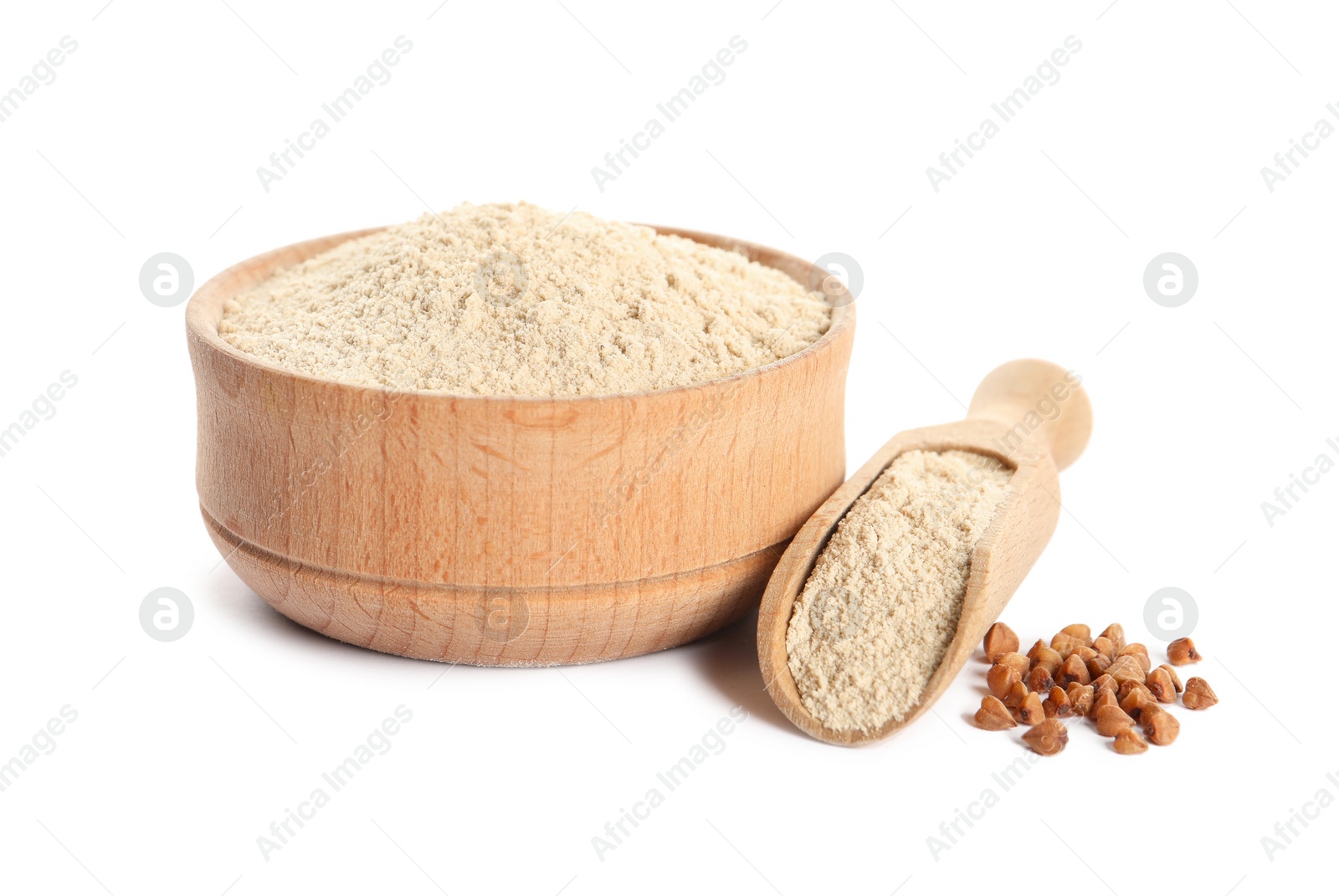 Photo of Bowl and scoop of buckwheat flour on white background