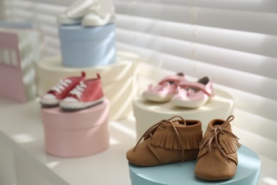 Small baby booties near window in store. Shopping concept