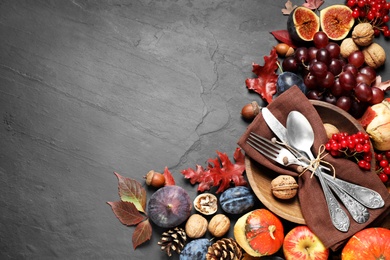 Flat lay composition with cutlery, autumn vegetables and fruits on grey background, space for text. Happy Thanksgiving day