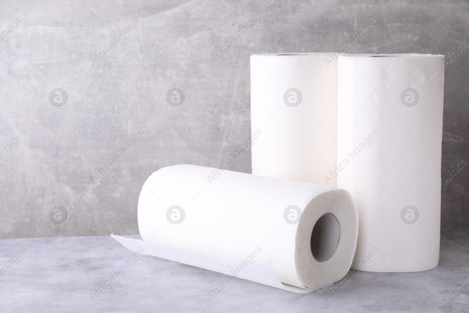 Photo of Rolls of paper towels on grey table