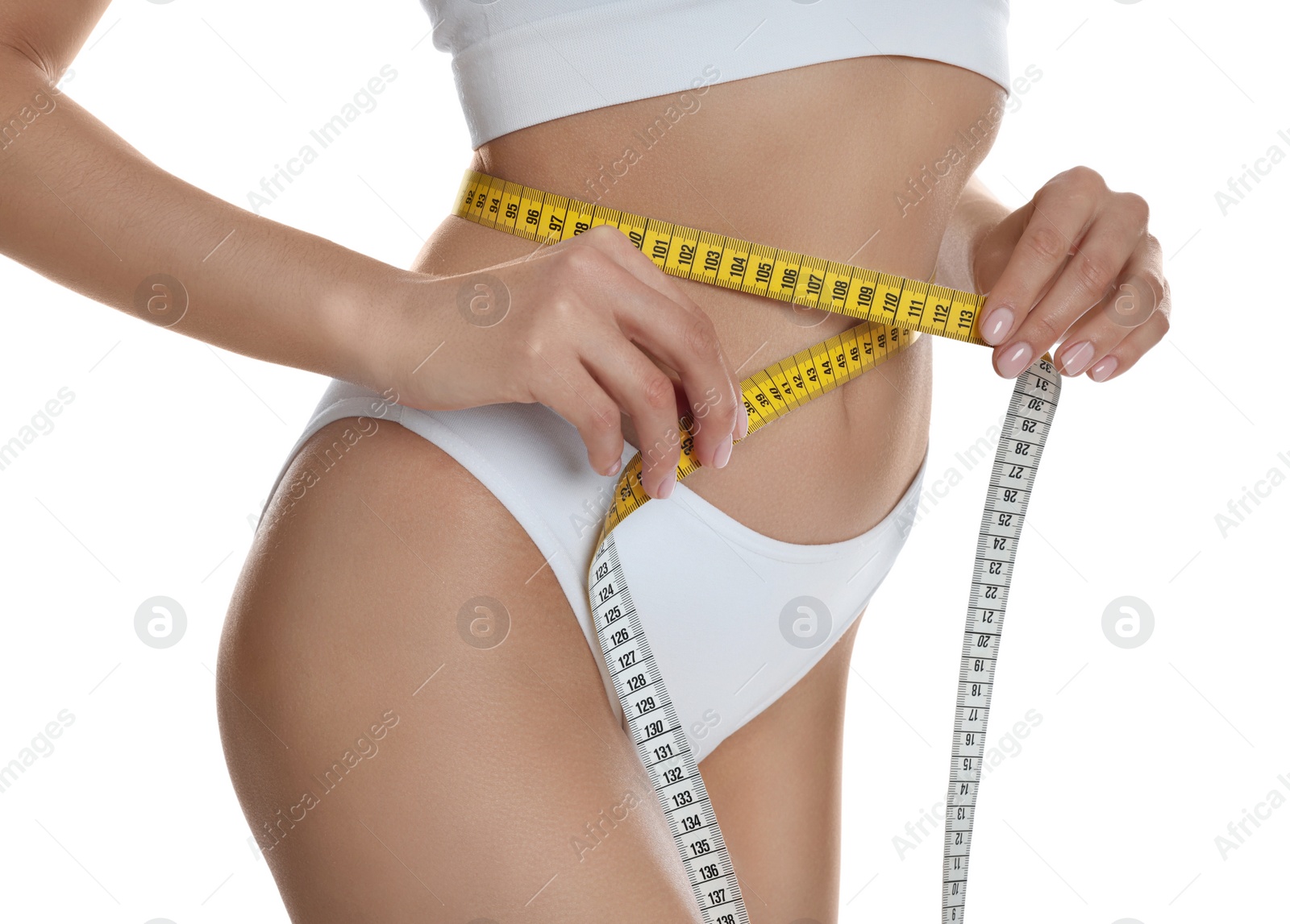 Photo of Young woman measuring waist with tape on white background, closeup