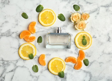 Photo of Beautiful composition with bottle of perfume on light background, flat lay