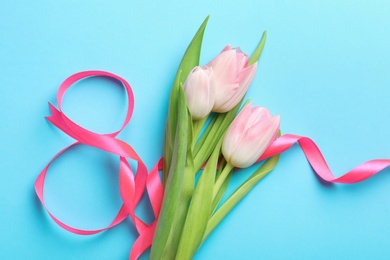 Photo of 8 March card design with tulips on light blue background, flat lay. International Women's Day