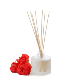 Photo of Aromatic reed freshener and roses on white background