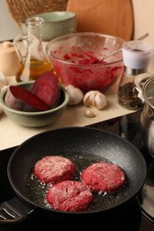 Photo of Cooking vegan cutlets in frying pan on stove