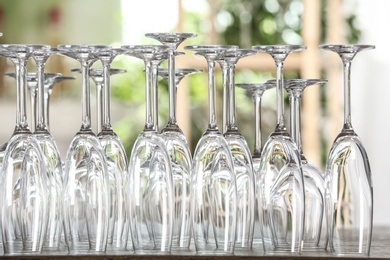 Photo of Empty glasses on wooden table against blurred background