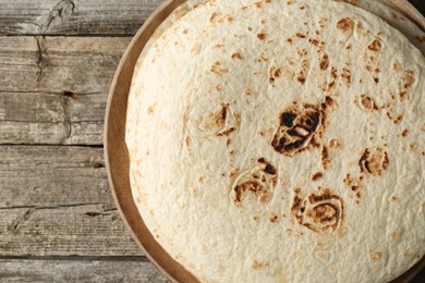 Stack of tasty homemade tortillas on wooden table, top view