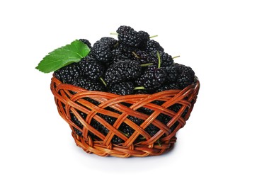 Photo of Ripe black mulberries in wicker bowl on white background