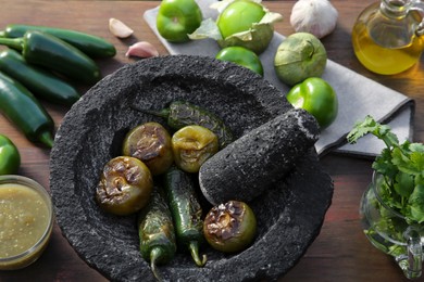 Different ingredients for cooking tasty salsa sauce on wooden table, above view