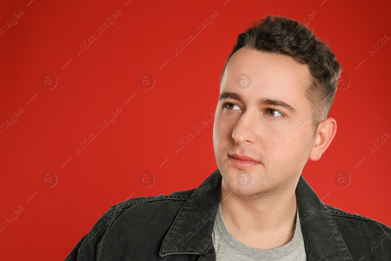 Photo of Portrait of young man on red background