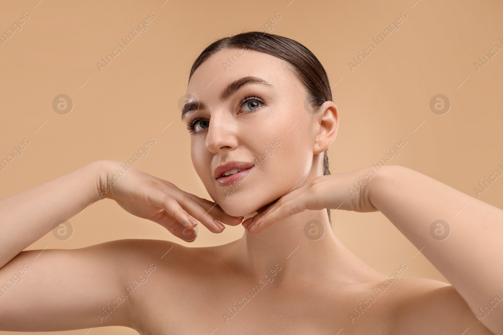 Photo of Beautiful woman touching her chin on beige background