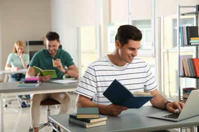 Students reading books and studying in library