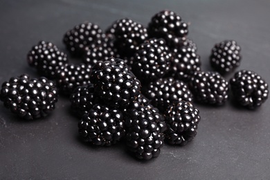 Photo of Pile of ripe blackberries on slate plate, closeup