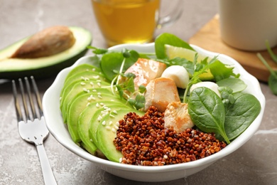 Delicious avocado salad with chicken on light grey marble table