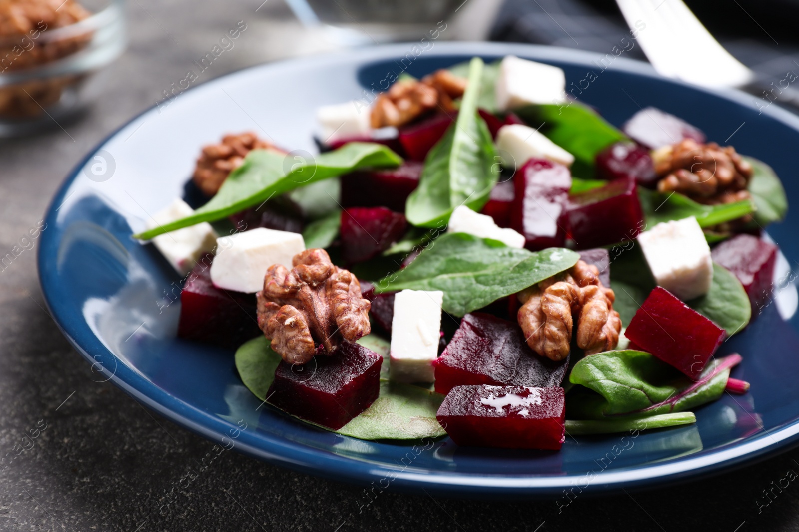 Photo of Fresh delicious beet salad on grey table, closeup