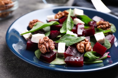 Fresh delicious beet salad on grey table, closeup