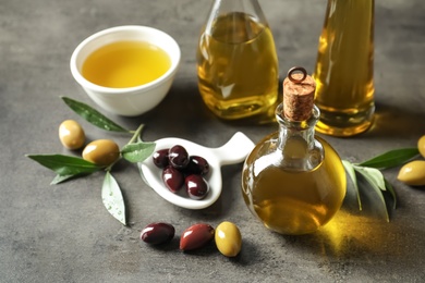 Composition with fresh olive oil on grey background