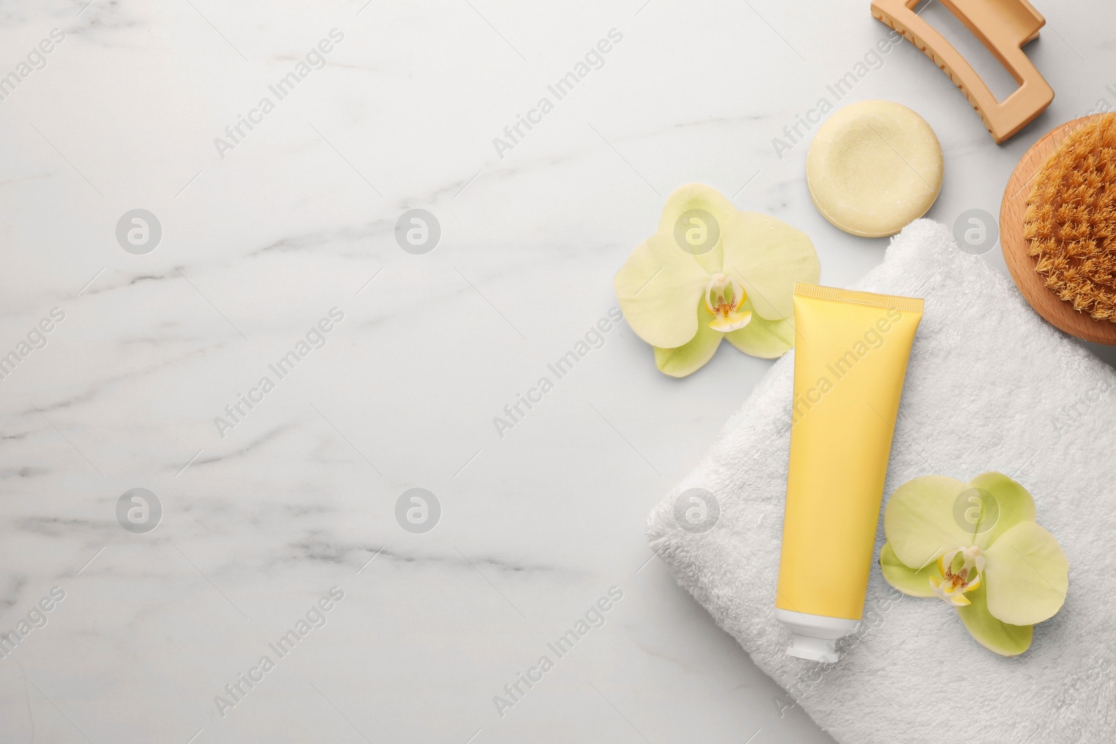 Photo of Flat lay composition with spa products and beautiful flowers on white marble table. Space for text