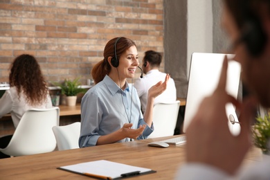 Technical support operator with headset at workplace