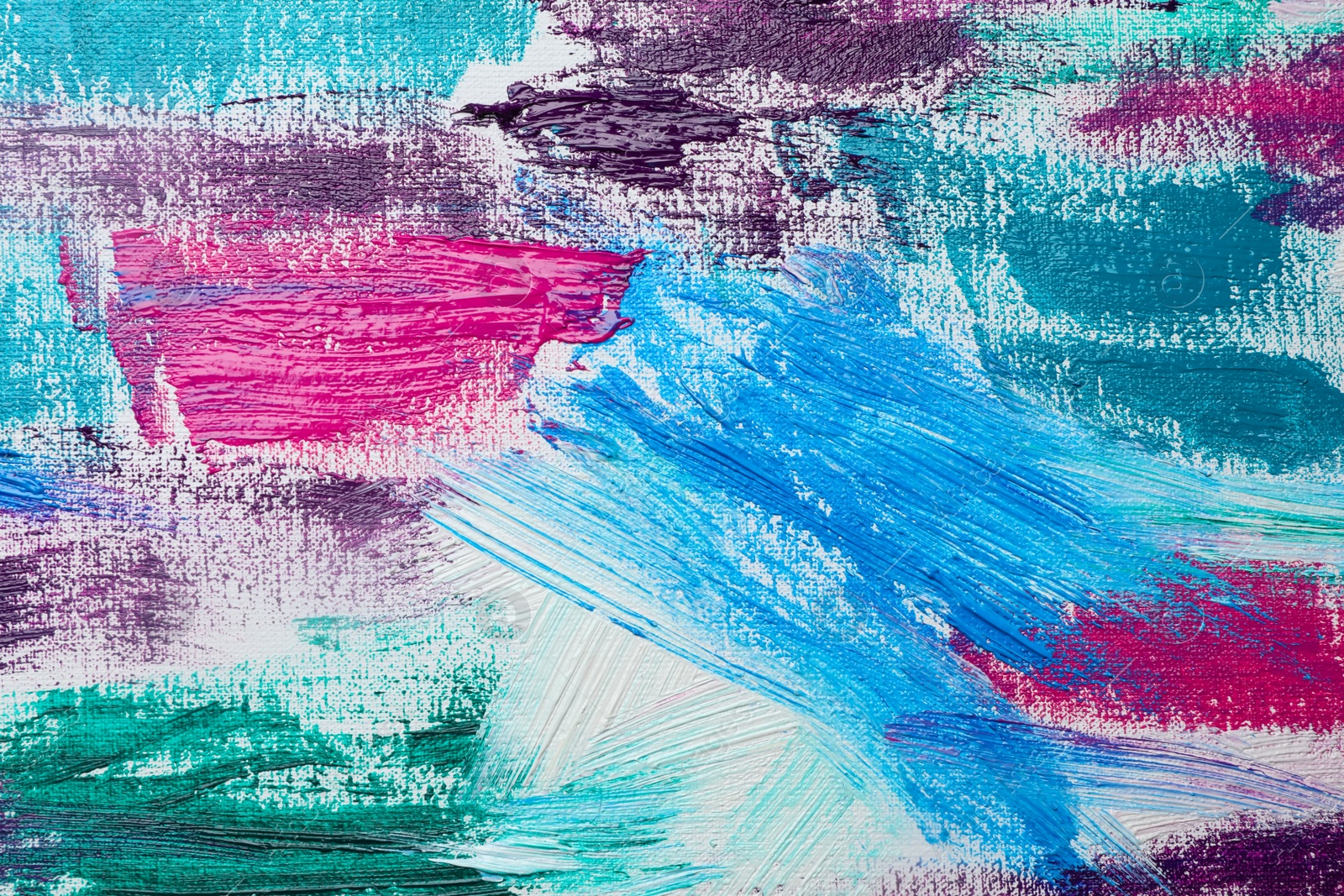 Photo of Strokes of colorful acrylic paints on white canvas, closeup