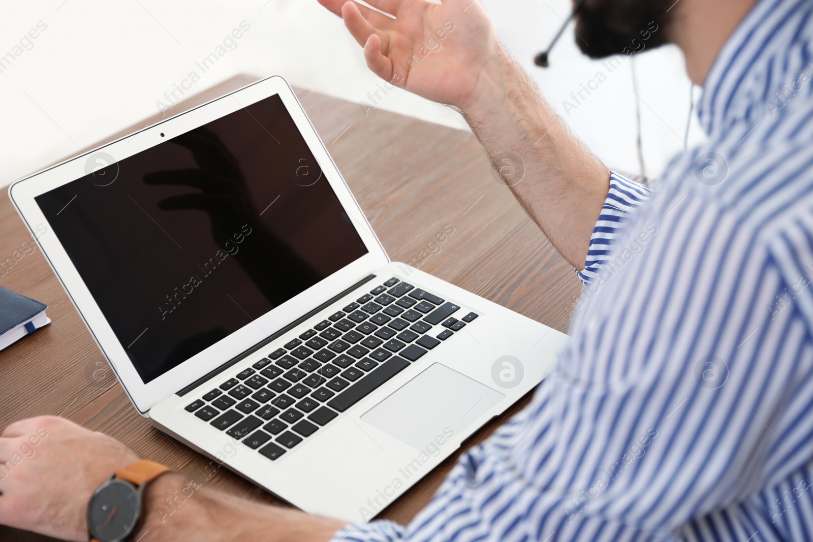 Photo of Man using video chat on laptop in home office, closeup. Space for text