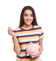 Photo of Portrait of young woman with piggy bank and coin on white background