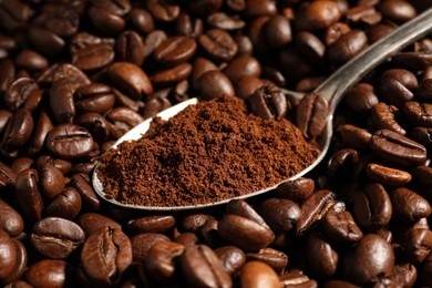 Photo of Spoon with ground coffee on roasted beans, closeup