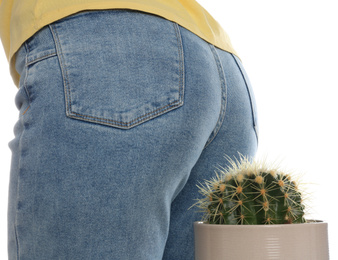 Photo of Woman sitting down on cactus against white background, closeup. Hemorrhoid concept