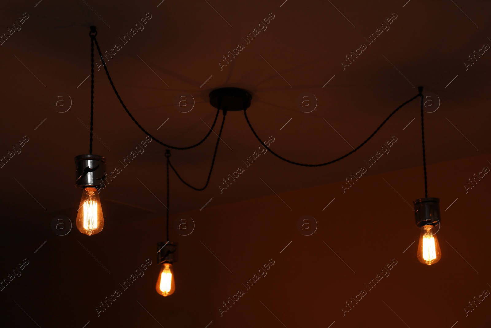 Photo of Lamp bulbs on ceiling in dark room