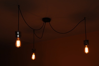 Photo of Lamp bulbs on ceiling in dark room