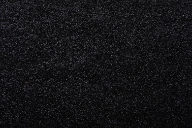 Photo of Beautiful shiny black glitter as background, closeup