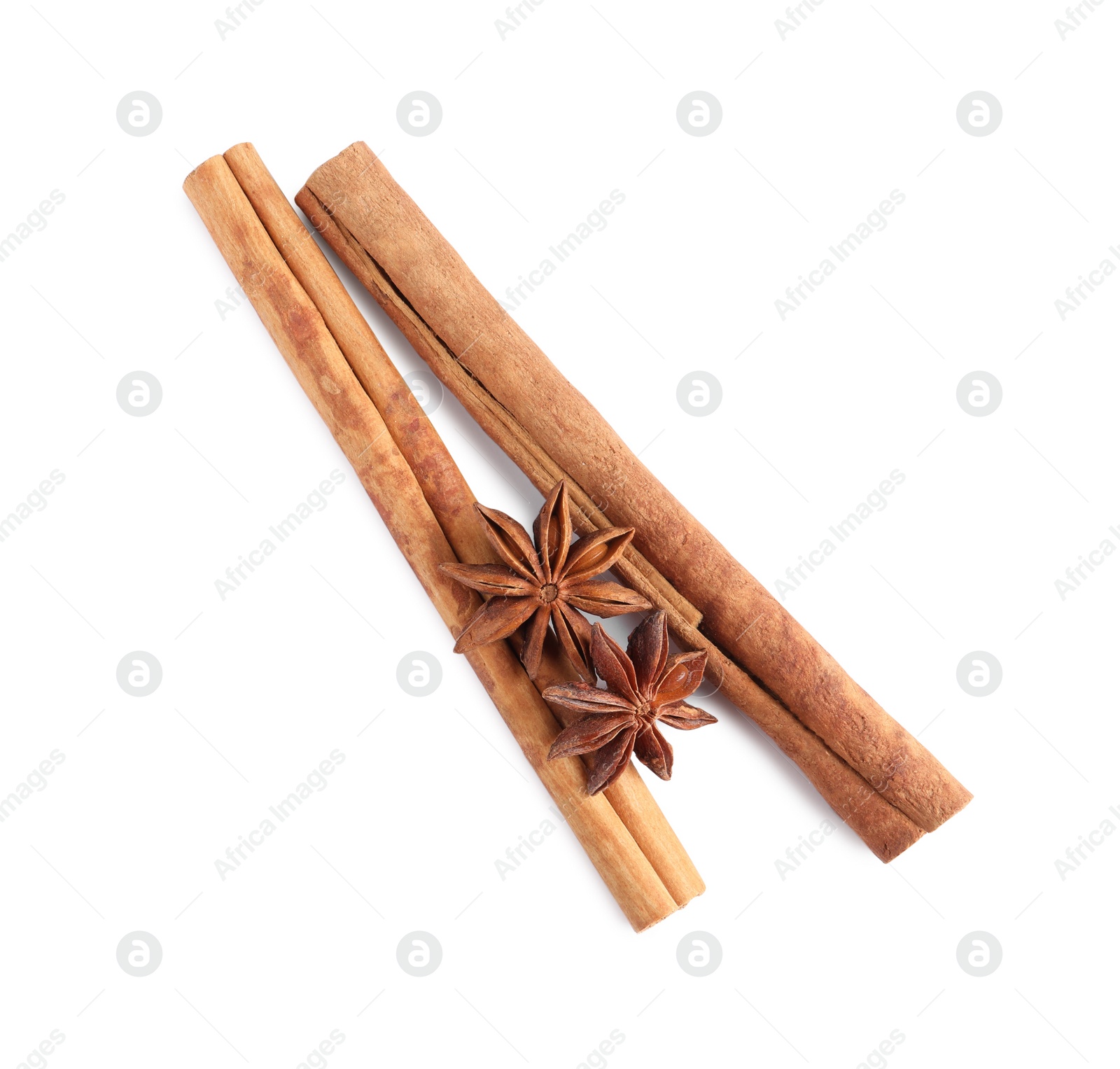 Photo of Cinnamon sticks and anise stars isolated on white, top view