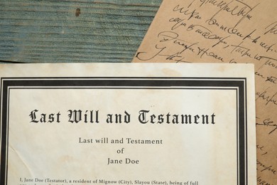 Photo of Last Will and Testament with letter on rustic wooden table, top view