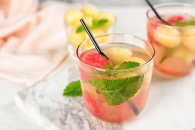 Photo of Glass with tasty watermelon and melon ball drink on table