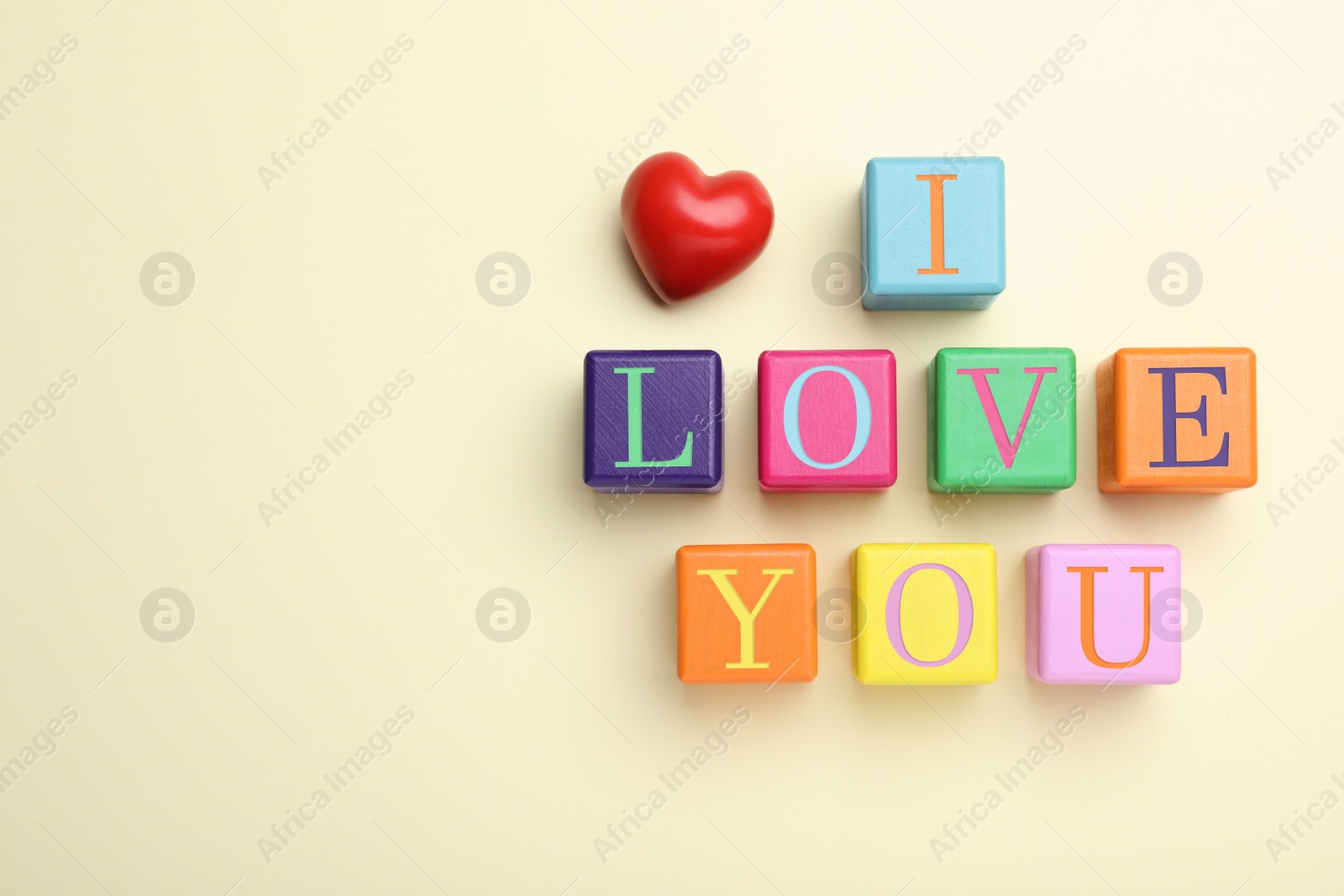 Photo of Phrase I love You made of color cubes on light background, flat lay. Space for text