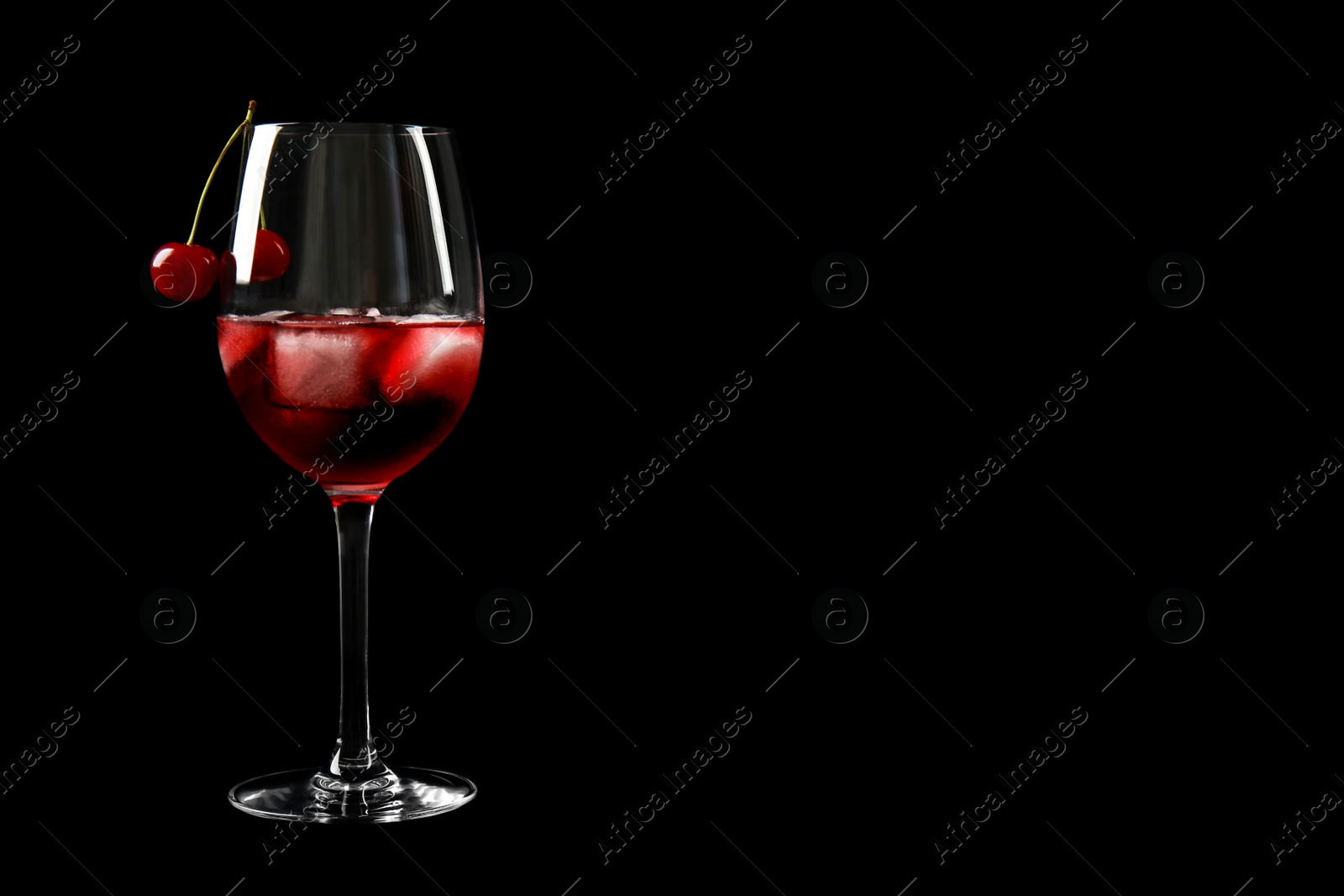 Photo of Delicious cherry wine with ripe juicy berries on black background. Space for text