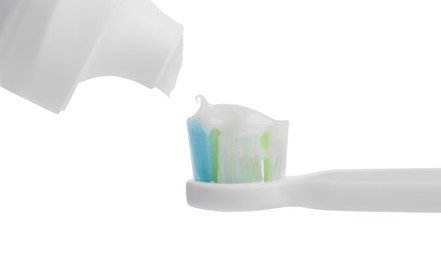 Photo of Applying paste on electric toothbrush against white background, closeup