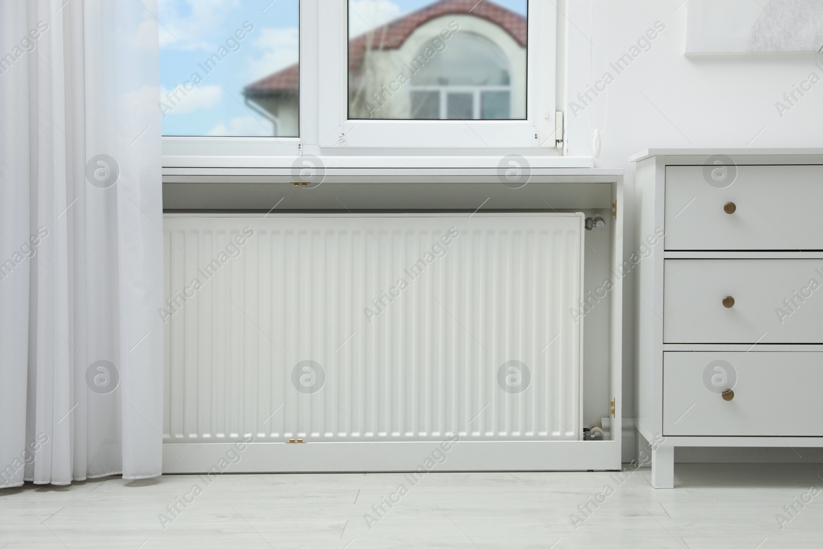 Photo of Modern radiator at home. Central heating system