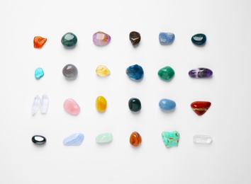 Photo of Different gemstones on white background, top view