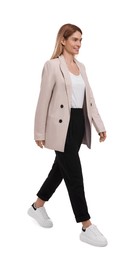 Photo of Beautiful happy businesswoman walking on white background