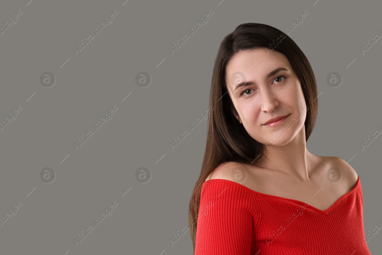 Photo of Portrait of beautiful young woman on grey background. Space for text