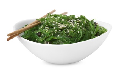 Photo of Tasty seaweed salad in bowl and chopsticks isolated on white