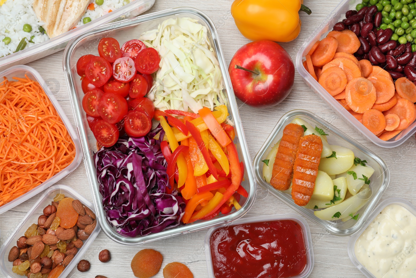 Photo of Set of containers and fresh food on white wooden table, flat lay