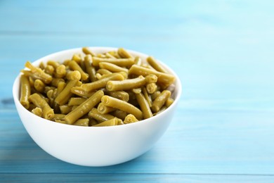 Canned green beans on light blue wooden table