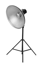 Studio flash light with reflector on tripod against white background. Professional photographer's equipment