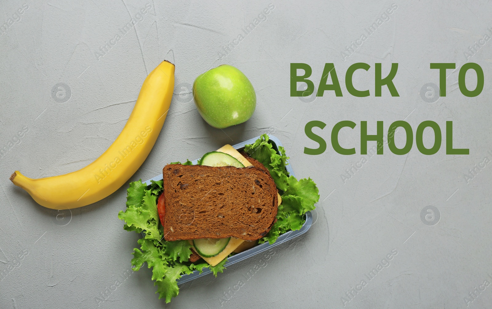 Image of Lunch box with tasty sandwich and fruits on light grey background, top view