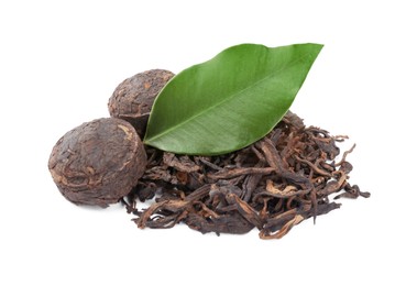 Photo of Cake shaped traditional Chinese pu-erh tea and fresh leaves isolated on white