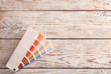 Photo of Color palette samples on wooden background